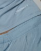 T-shirt smanicata in bielastico con drappeggio laterale • Azzurro polvere