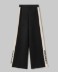 Pantalone In Maglia A Palazzo Con Bande In Contrasto E Logo In Punto Rovescio • Nero
